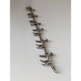 Silver steed greyhound bracelet crafted in silver with linked stylized horse figures for a unique greyhound silver bracelet