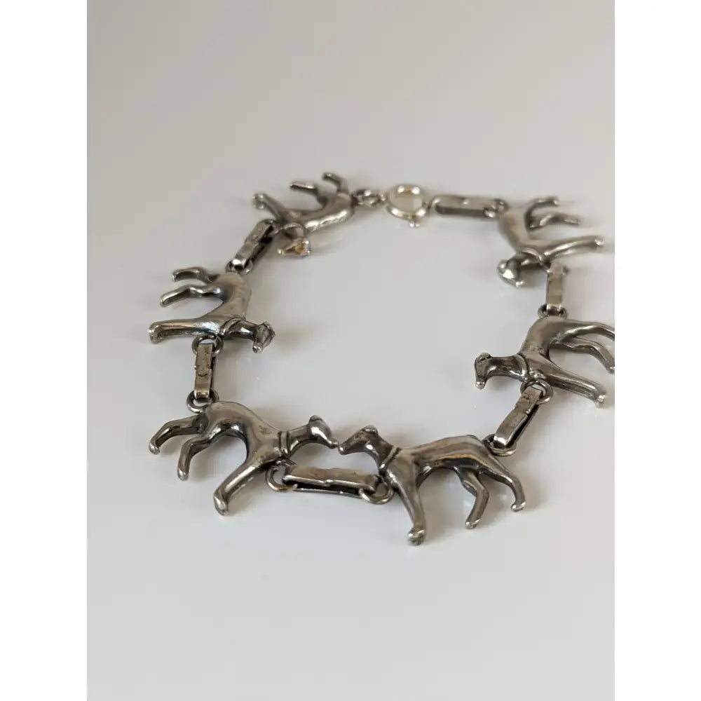 Silver steed greyhound silver bracelet crafted with linked horse figurines in a sleek continuous running pattern