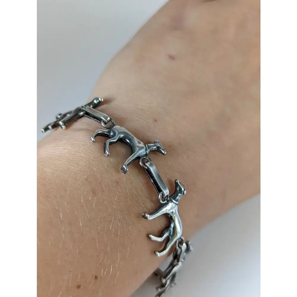Silver steed greyhound silver bracelet crafted with linked stylized running dog figures in a sleek silver tone