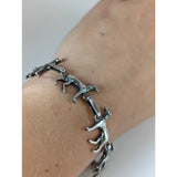 Silver steed greyhound silver bracelet crafted with linked stylized running dog figures in a sleek silver tone