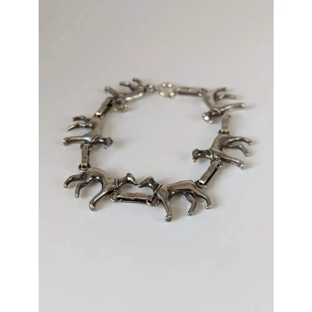 Silver steed greyhound silver bracelet crafted with linked silver-toned horse figurines in a running pose