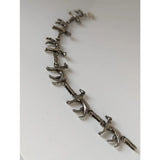 Silver steed greyhound silver bracelet crafted with articulated silver-toned dog figures linked in a continuous chain