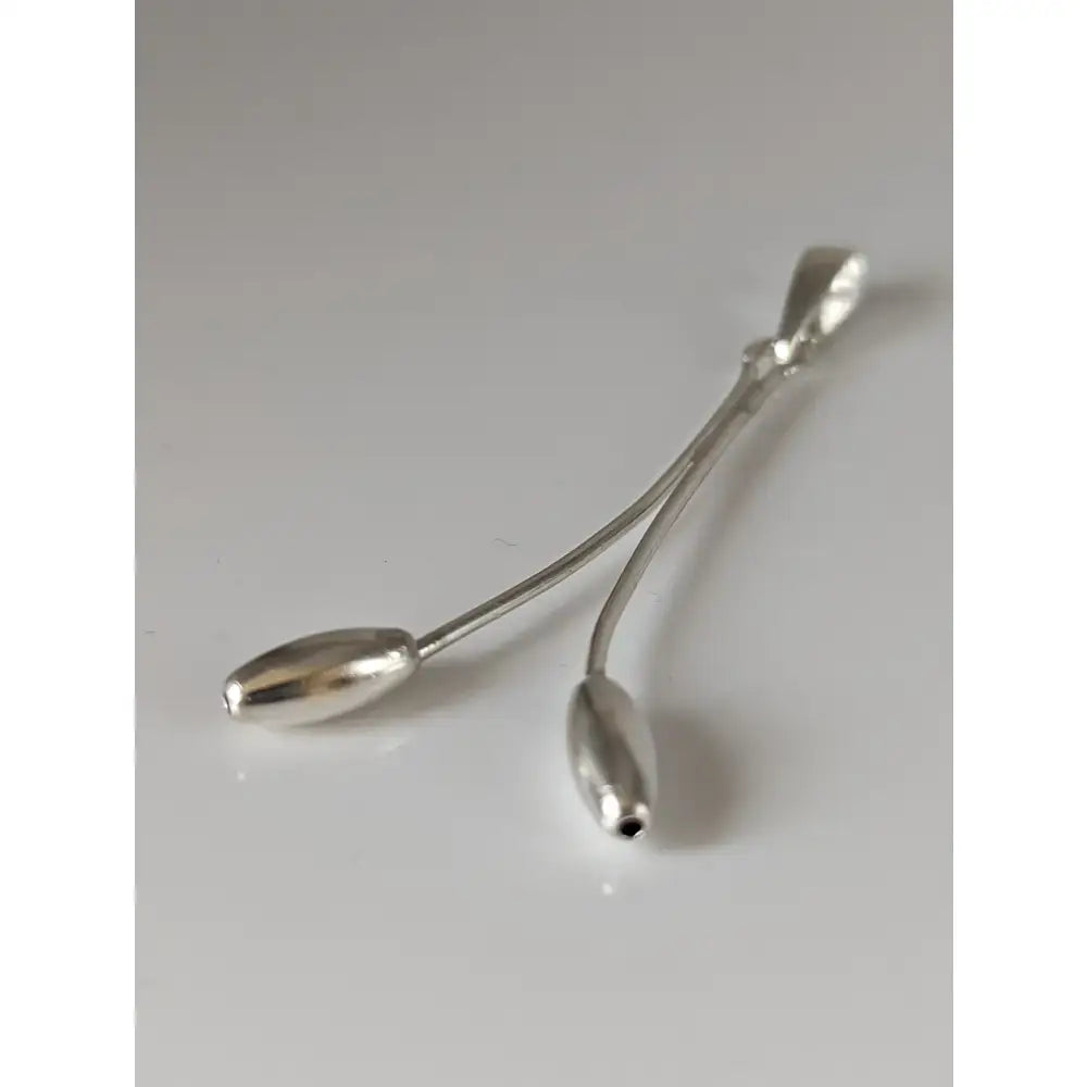Silver steed hanging silver pendant with two elongated teardrop charms connected by a slender wire stem silver pendant