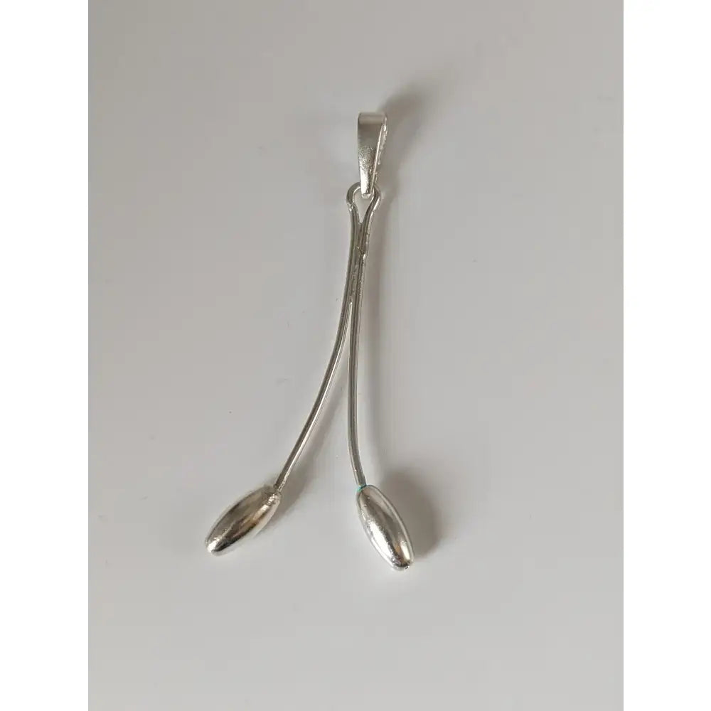 Silver pendant with two slender teardrop shapes curving from a central bail in silver steed hanging stem style