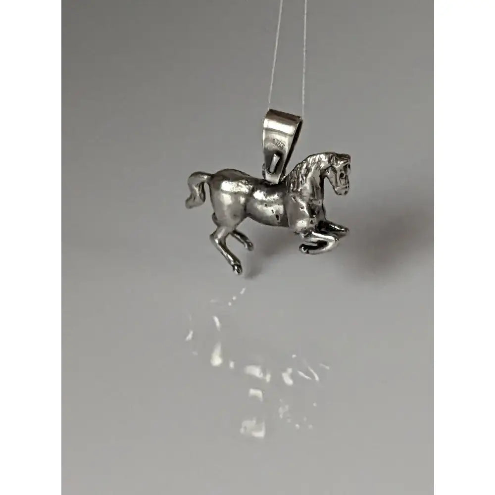 Silver steed haute ecole pendant featuring a detailed silver horse with a polished metallic finish equestrian pendant