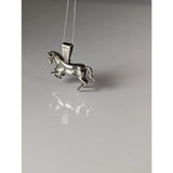 Silver steed haute ecole pendant featuring a polished silver equestrian pendant with detailed sculpted horse design