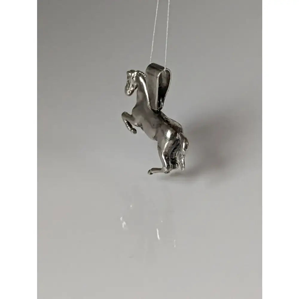 Silver steed haute ecole pendant featuring a detailed silver equestrian pendant with polished metallic finish