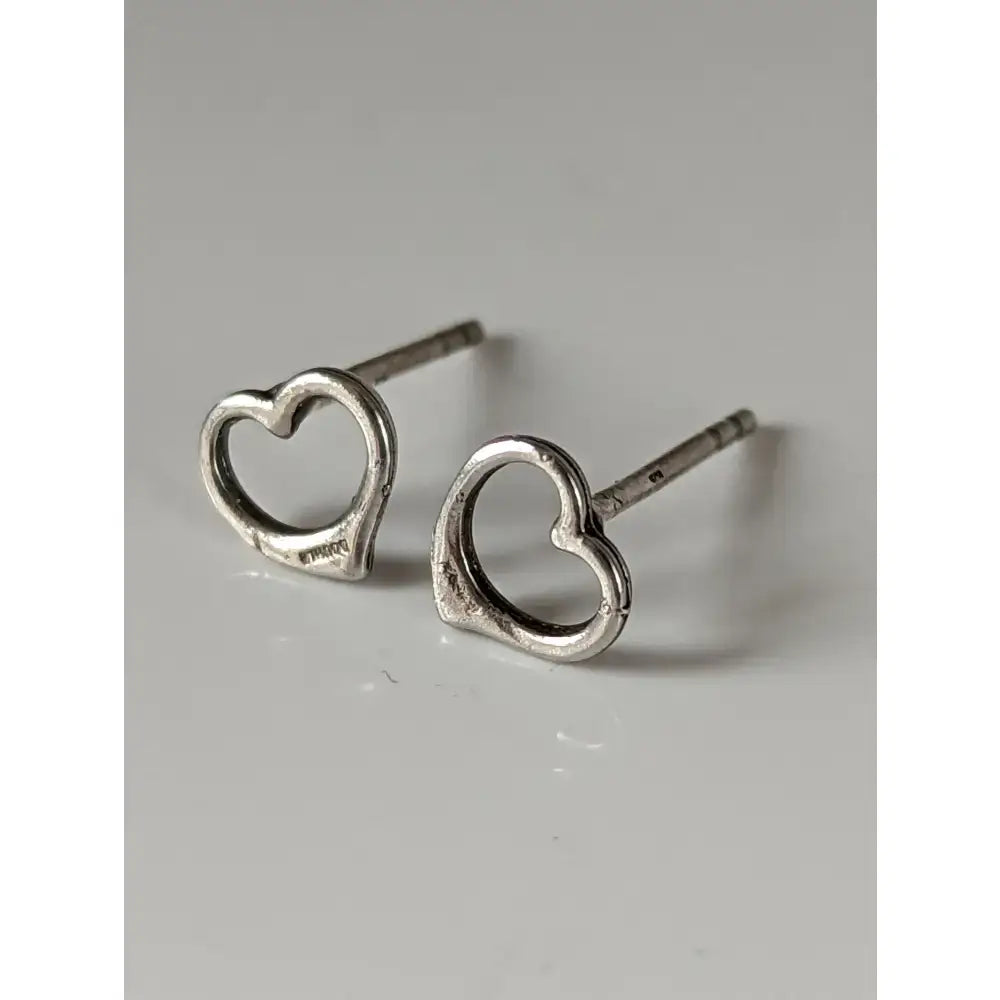 Silver steed heart stud earrings featuring minimalist open heart stud design in shiny silver material