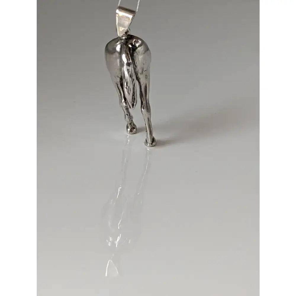 Silver steed hindquarters sterling silver pendant showing polished metallic horse hindquarters detail