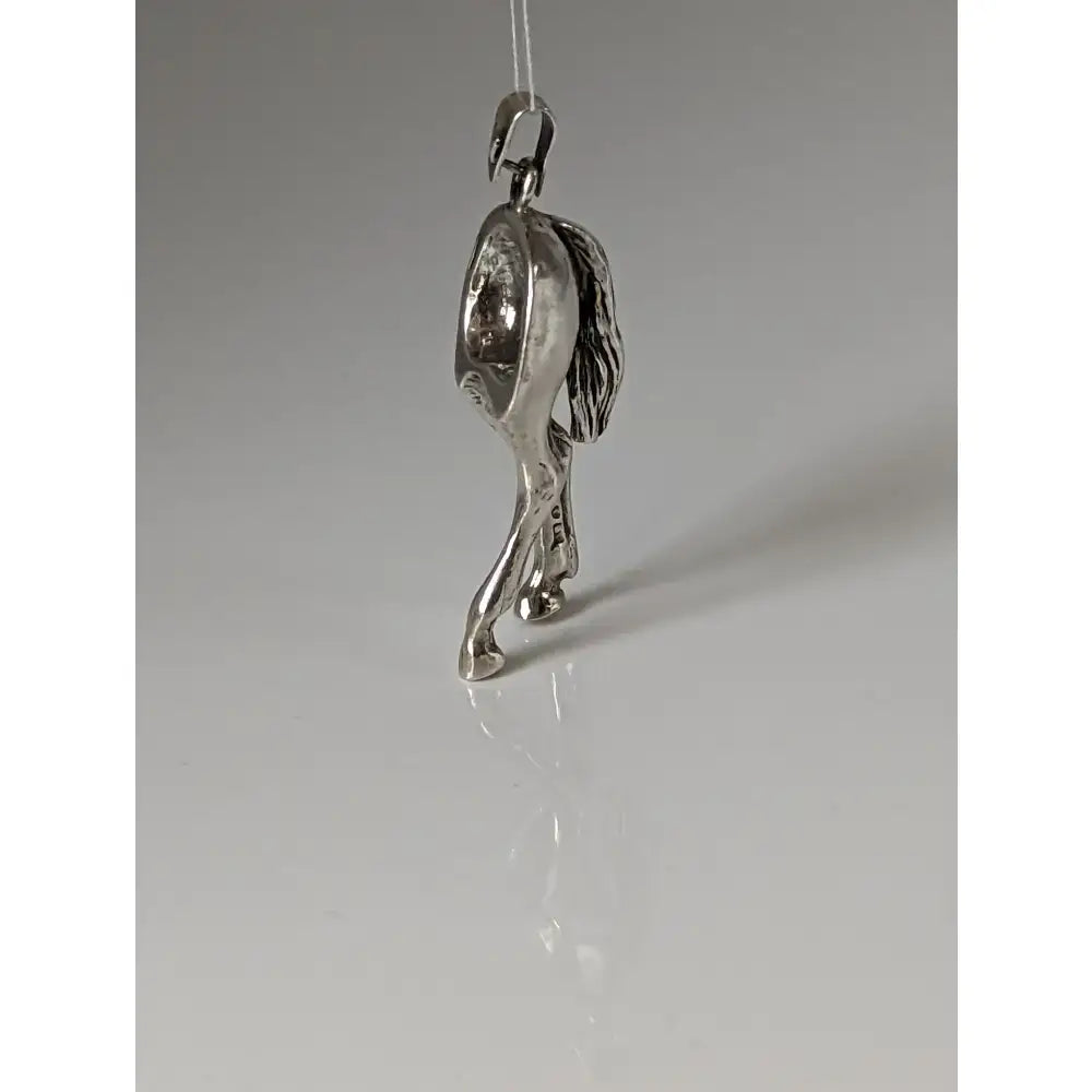 Silver steed hindquarters sterling silver pendant shaped like a horse with detailed mane and legs hanging from a loop