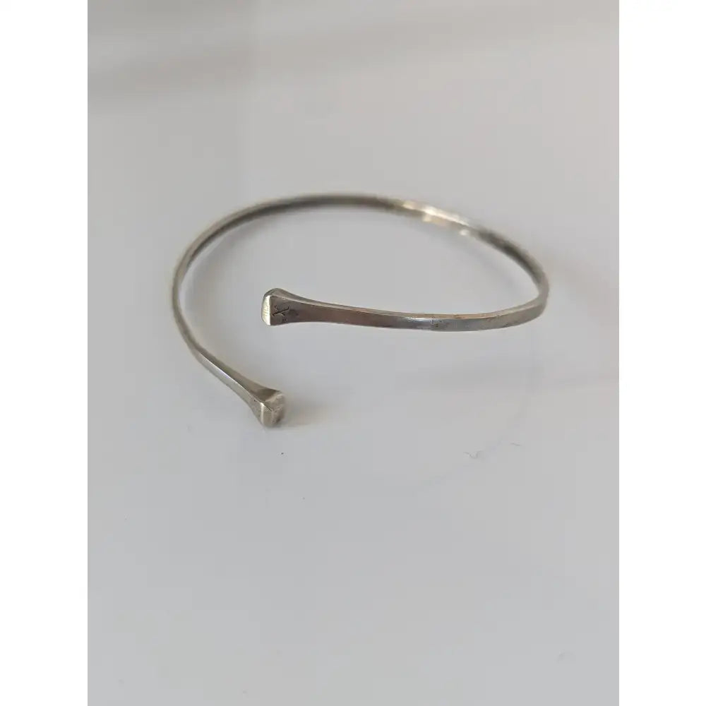 Silver steed hoofnail open-ended bangle with hammered sterling silver texture and tapered ends