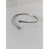 Silver steed hoofnail open-ended bangle with hammered sterling silver texture and tapered ends