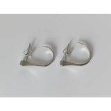 Silver steed hoofnail stud earrings are silver-toned minimalist hoops with sleek design and small decorative elements