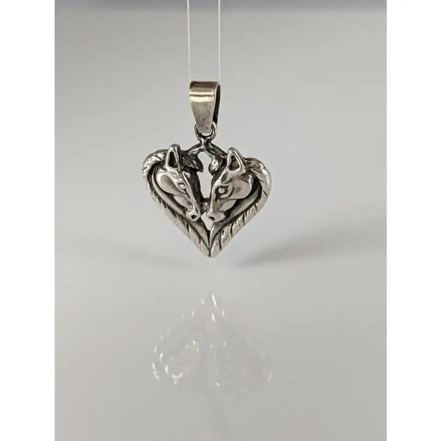 Silver steed horse heart pendant with polished silver metal and detailed horse heads facing each other