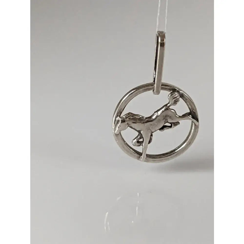 Silver steed horse pendant with an intricate mid-gallop horse design in a circular silver frame with matching bail