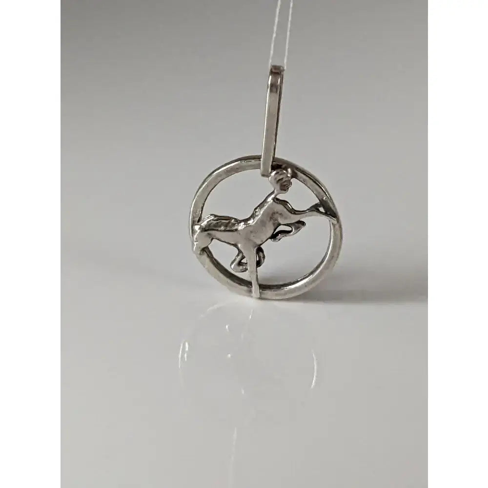 Silver steed horse silver pendant with a stylized figure riding a horse in an open circular silver frame