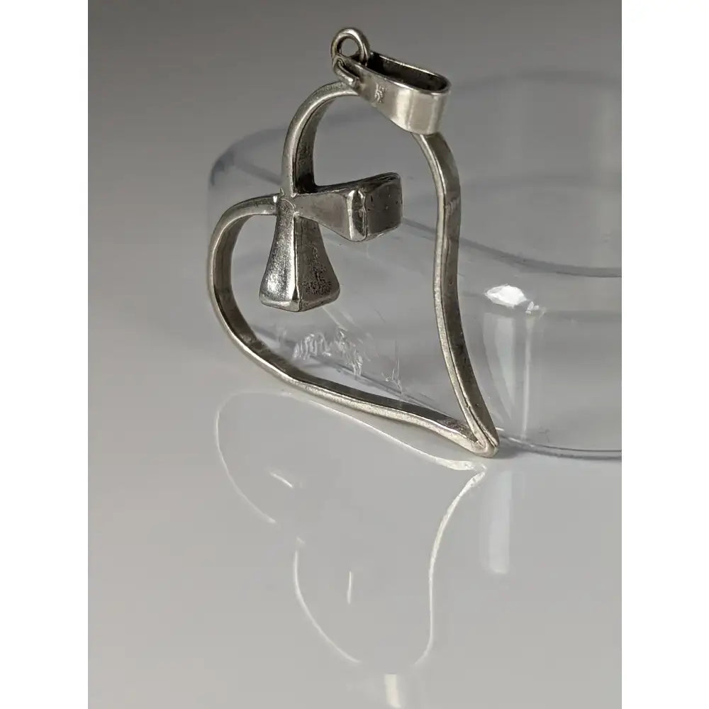 Silver steed horseshoe heart silver pendant with a small bell in the center made of silver metal
