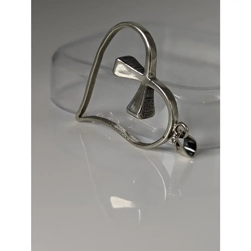 Silver steed horseshoe heart silver pendant featuring a textured silver pendant with an ankh symbol and attachment loop