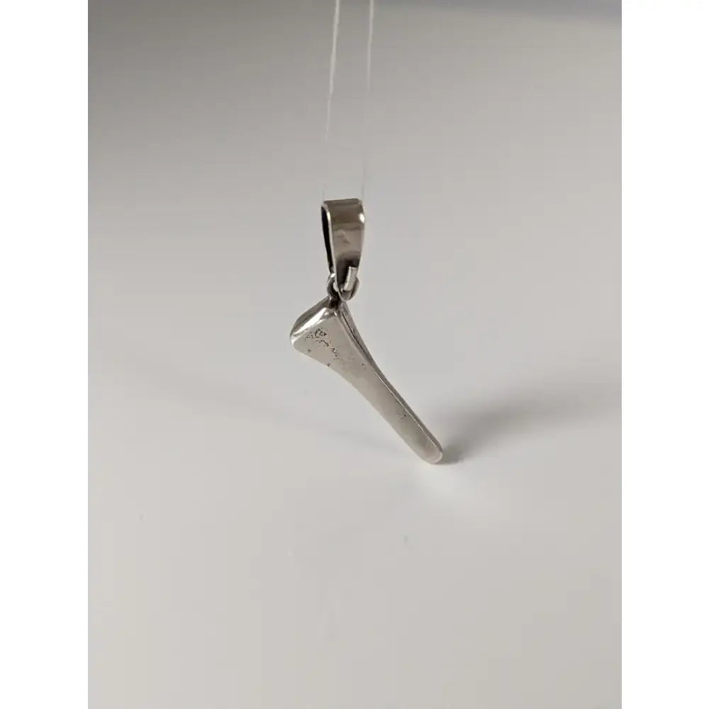 Silver steed silver pendant shaped like a polished horseshoe nail with a loop for hanging