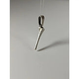 Silver pendant shaped like a stylized horseshoe nail with polished silver steed finish and engraved detail near top