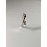 Silver pendant shaped like a minimalist high-heeled shoe made from silver steed horseshoe nail metal
