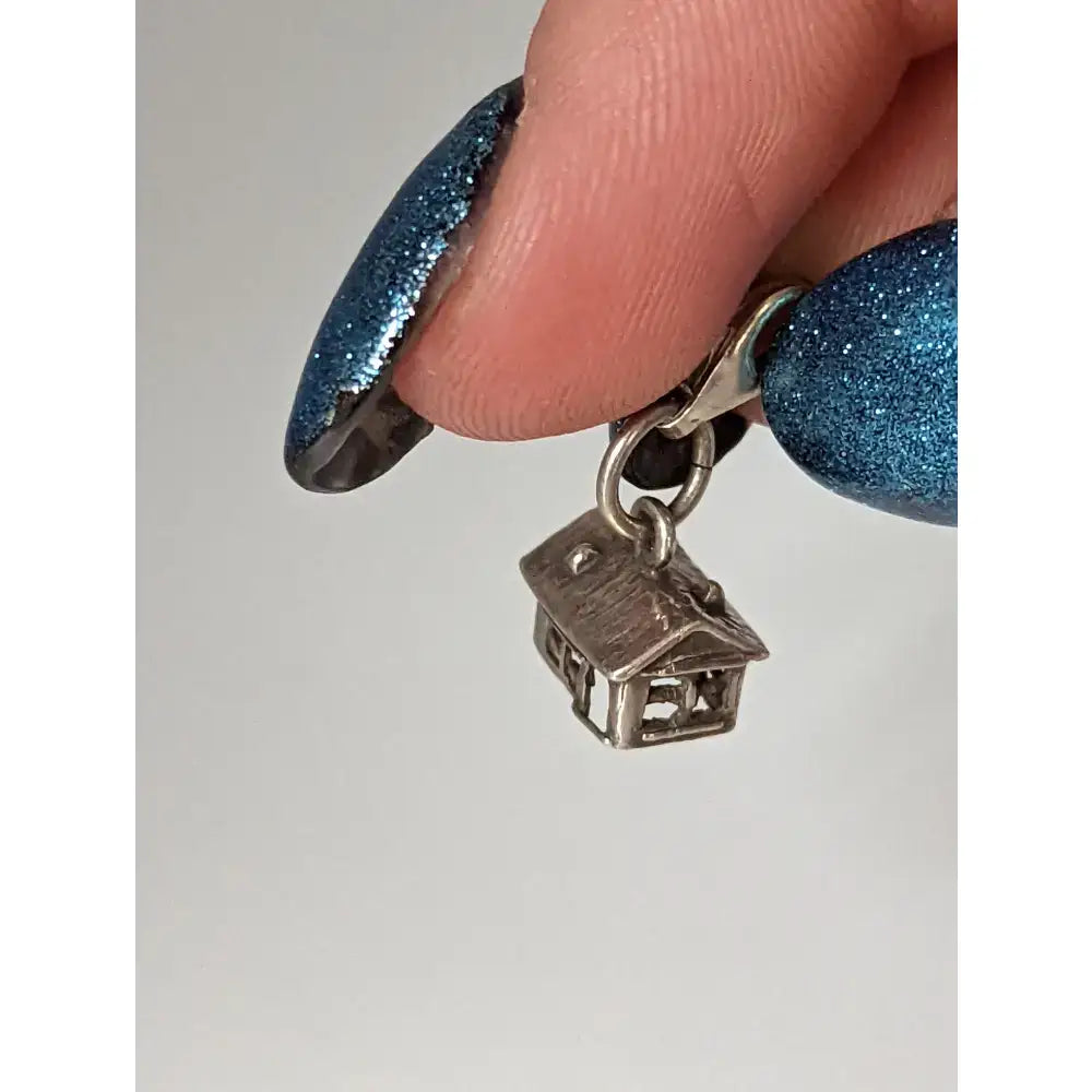Silver steed house silver charm featuring detailed roof and window cutouts on a metal clasp perfect for equestrian jewelry