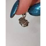 Silver steed house silver charm featuring a detailed roof and window cutouts perfect for equestrian jewelry fans