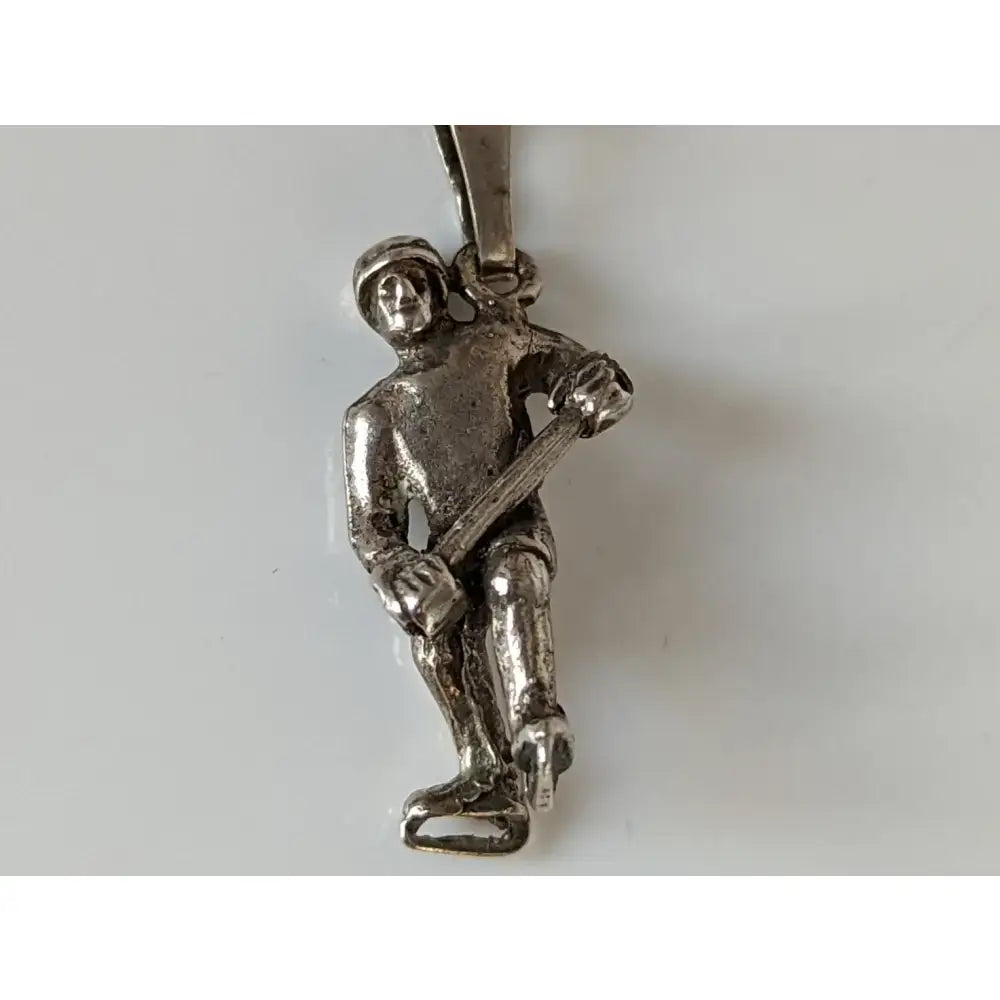 Silver steed ice hockey silver pendant showing a silver firefighter on ice skates holding an axe for sports fans