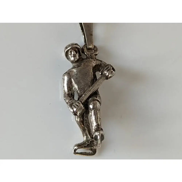 Silver steed ice hockey silver pendant showing a silver firefighter on ice skates holding an axe for sports fans