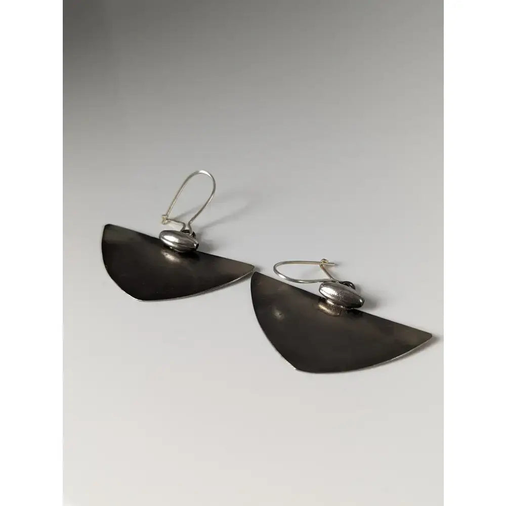 Silver steed isosceles dropped earrings featuring silver-toned matte semi-circles with small oval accents