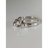 Silver steed jiggly balls silver ring with five polished silver beads clustered on a smooth rounded band