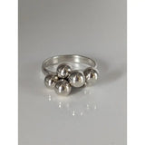 Silver steed jiggly balls silver ring with five polished silver beads clustered on a sleek minimalist band