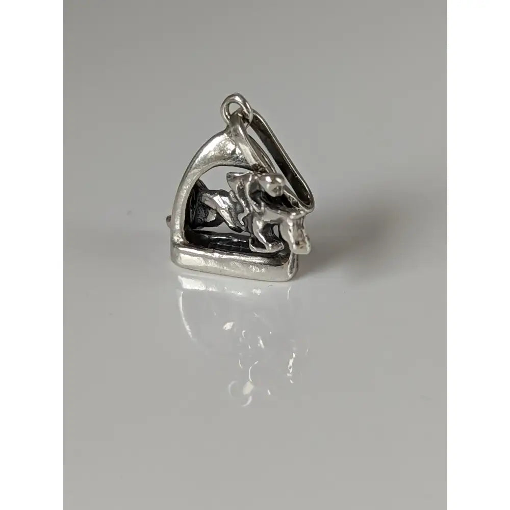 Silver steed jump silver pendant featuring a stirrup jockey charm with polished metallic finish and detailed motion design