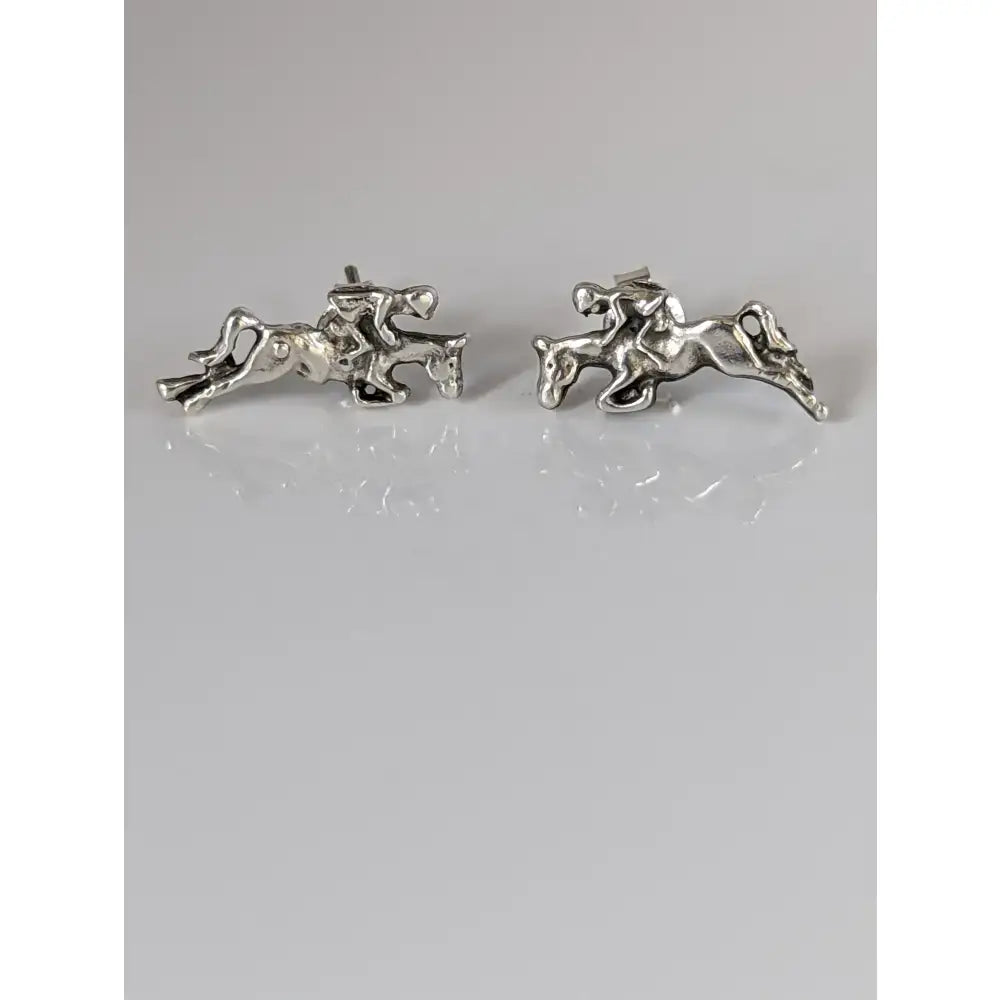 Silver steed jumping sterling silver earring studs with detailed horse and rider figures in mid-gallop design