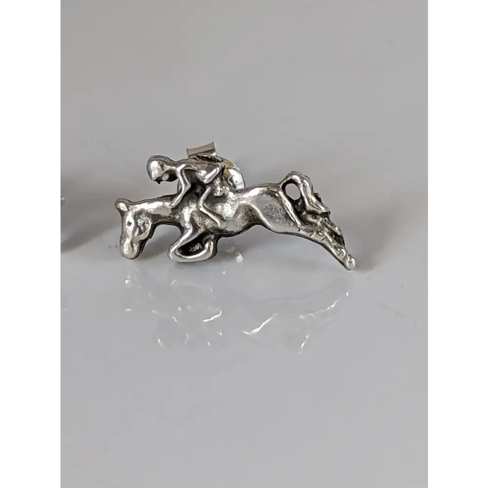 Silver steed jumping sterling silver stud earrings with detailed rider on horseback in mid-jump design