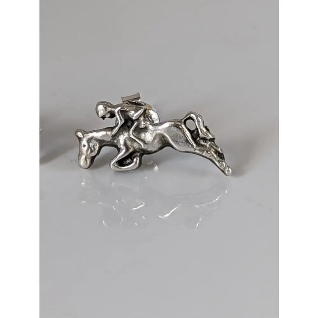 Silver steed jumping sterling silver stud earrings with detailed rider on horseback in mid-jump design
