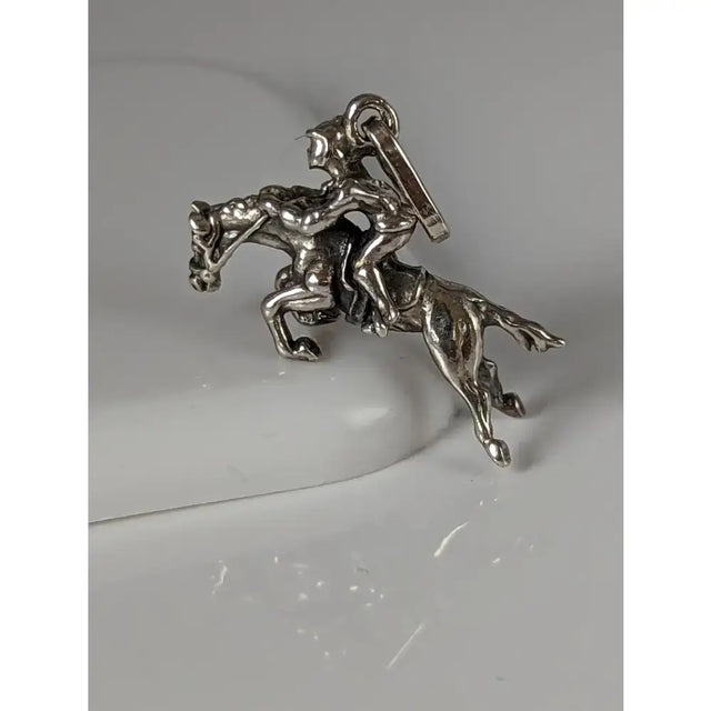 Silver steed jumping jockey silver pendant with detailed rider on horseback in metallic silver equestrian charm design