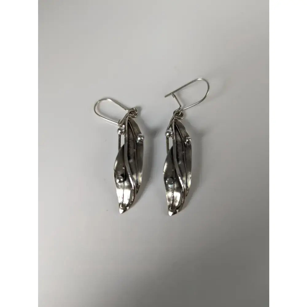 Silver steed kelp dropped earrings with textured layered silver leaf design and small spherical accents