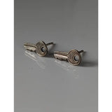 Silver steed key stud earrings featuring silver key-shaped stud earrings with a textured metallic finish