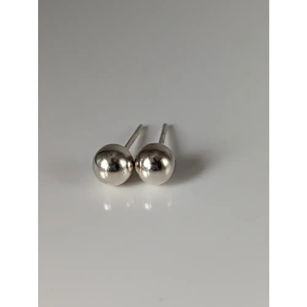 Silver steed large sterling silver ball stud earrings with polished reflective spherical heads and slender posts