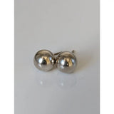 A pair of simple round silver steed large balls stud earrings with a polished metallic finish