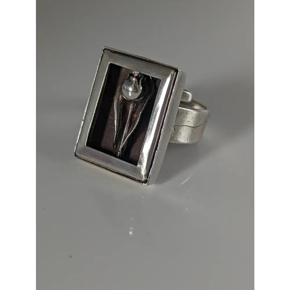 Silver steed large silver ring with a sculpted abstract figure and pearl accent in a frame silver ring design