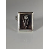 Silver steed large frame silver ring with a raised tulip design and pearl center on a dark background