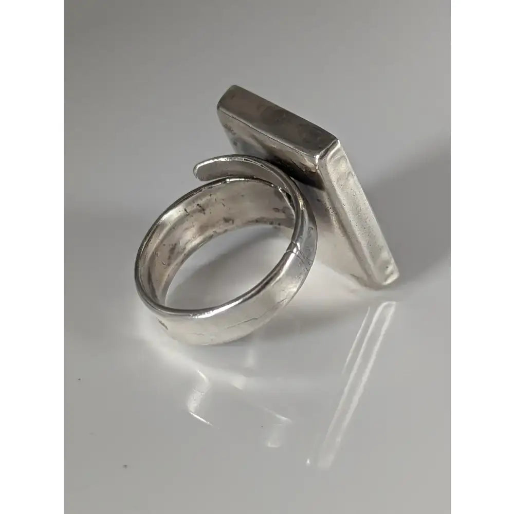 Silver steed large frame silver ring with a hammered texture and an adjustable band featuring a rectangular face
