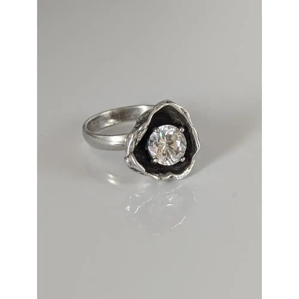 Silver steed large flower silver ring with a round clear zirconia in a textured blackened metal setting for equestrian jewelry
