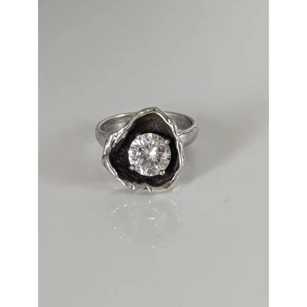 Silver steed large flower silver ring with a clear zirconia stone in a textured blackened metal setting perfect for equestrian jewelry