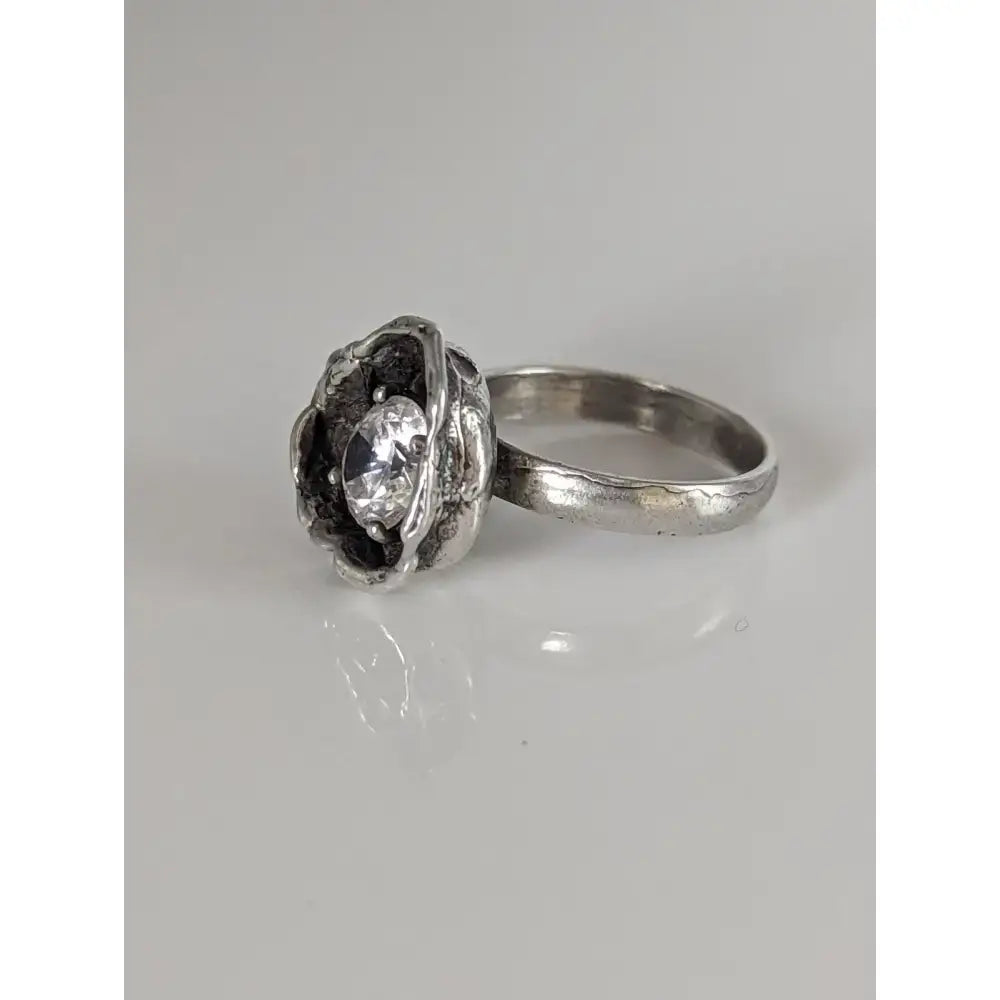 Silver steed large silver flower ring with textured organic setting holding oval-cut clear zirconia gemstone equestrian jewelry