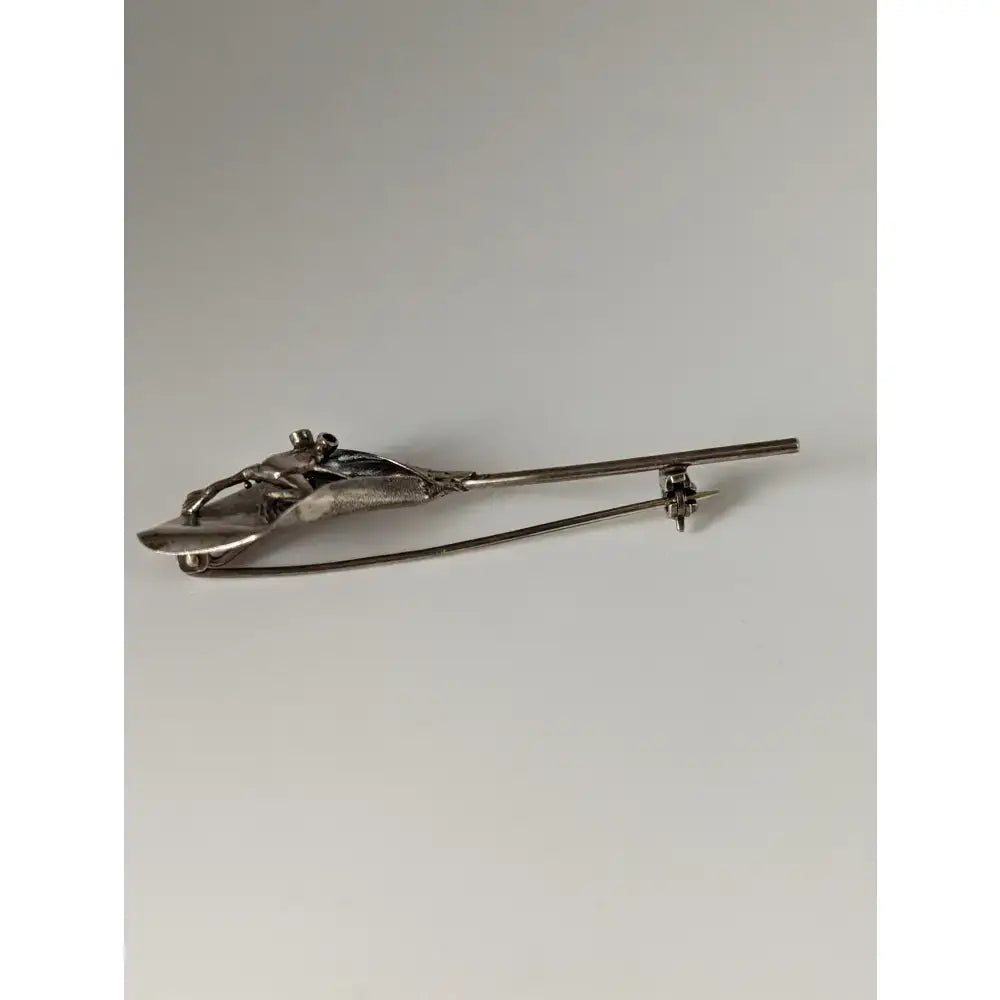 Silver steed leaf frog silver brooch in silver tone metal with abstract figure and textured flowing lines design