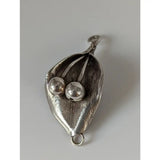 Silver steed leaf silver pendant with two polished sterling silver beads nestled in textured leaf design