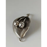 Silver steed leaf silver pendant with two polished beads nestled in textured sterling silver leaf design